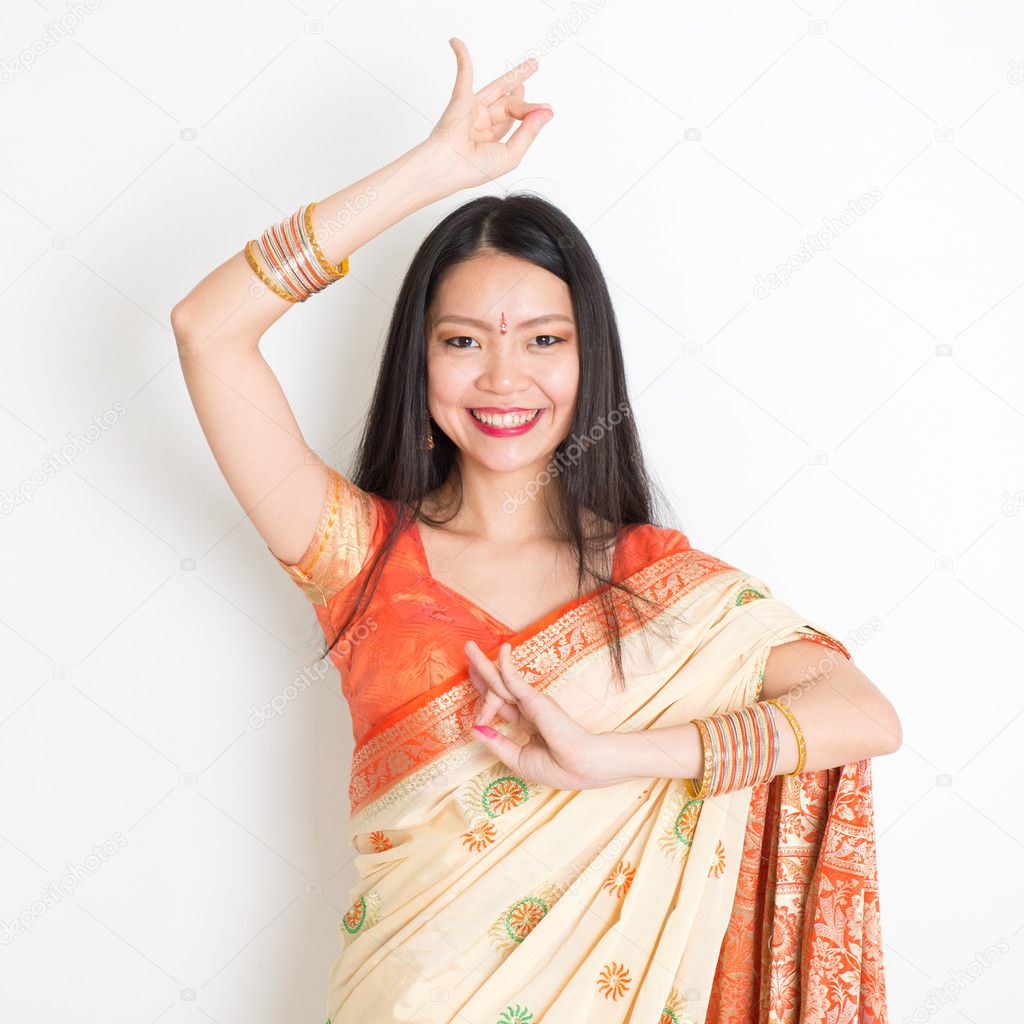 Young girl in Indian sari dress dancing