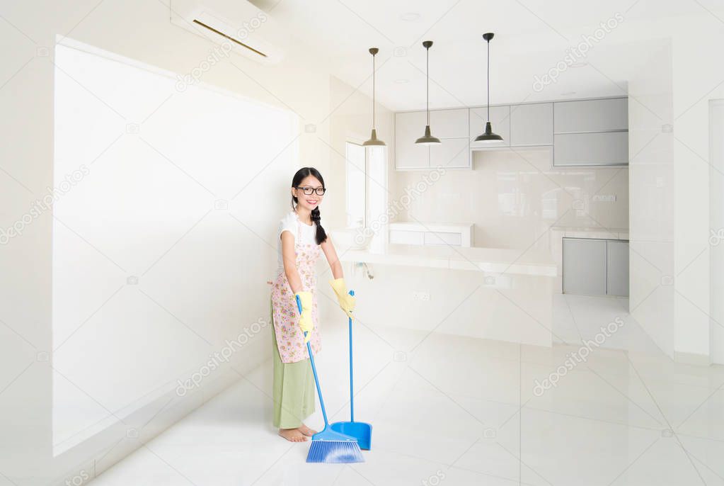 Woman Cleaning house with broom