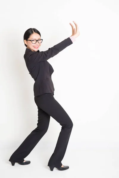 Asian businesswoman pushing something — Stock Photo, Image