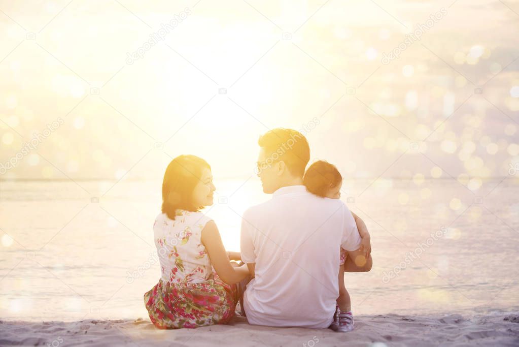 Family enjoying sunset view at beach