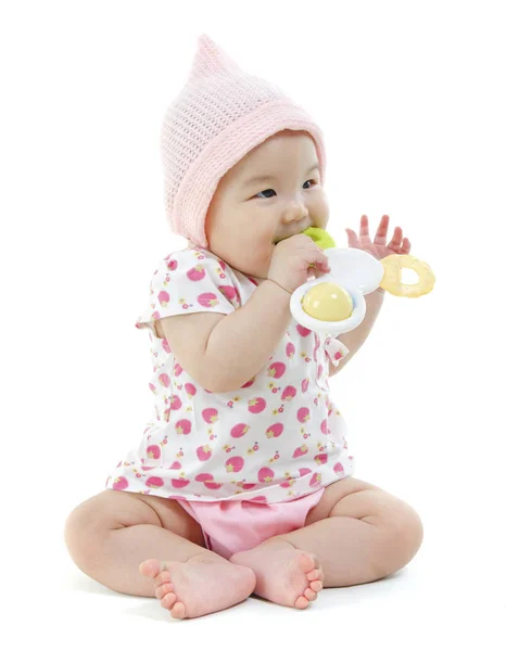 Asian baby girl biting on teething toy — Stock Photo, Image