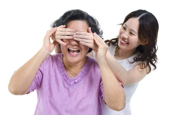 Daughter covering mother eyes — Stock Photo, Image