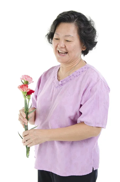 Senior woman and carnation flower on mothers day — Stock Photo, Image