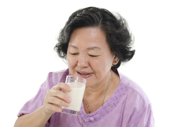 Senior woman drinking soy milk — Stock Photo, Image
