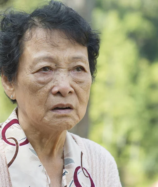 Upset Asian elderly woman — Stock Photo, Image