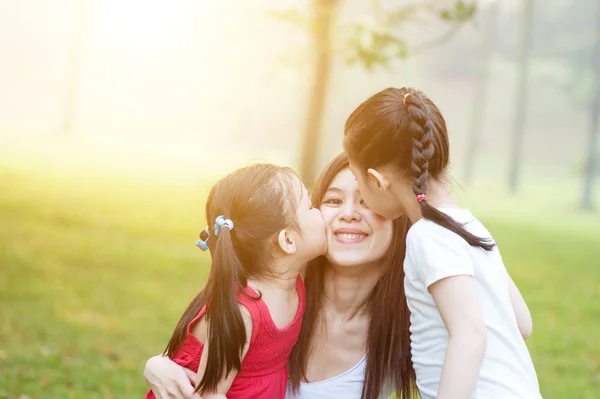 Daughters kissing mother. — Stock Photo, Image