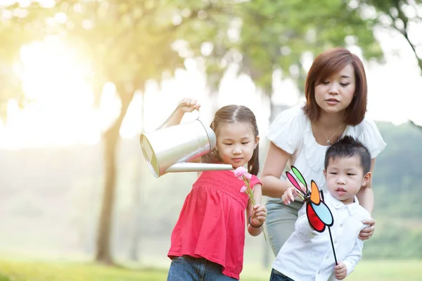 Aziatische moeder en kinderen spelen buiten Park. — Stockfoto
