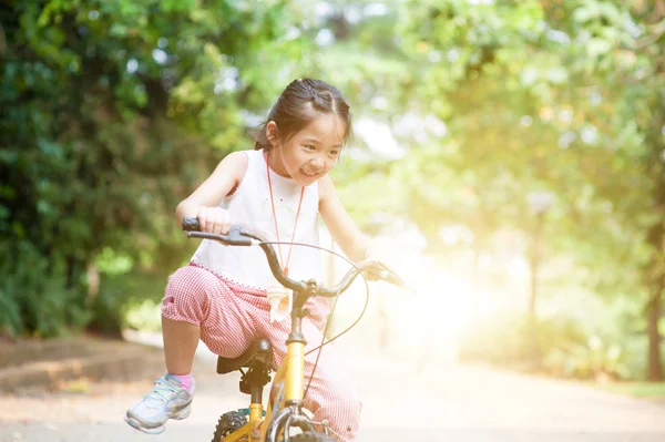 Active Asian child riding bike outdoor. — Stock Photo, Image