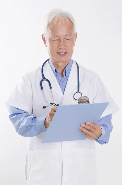 Asian medical doctor writing report — Stock Photo, Image