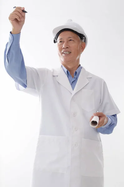 Old Asian senior architect writing — Stock Photo, Image