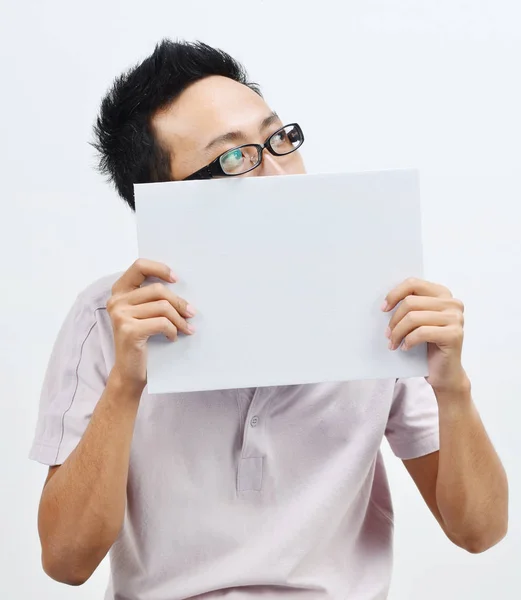 Asiático hombre holding blanco papel tarjeta cubierta boca — Foto de Stock