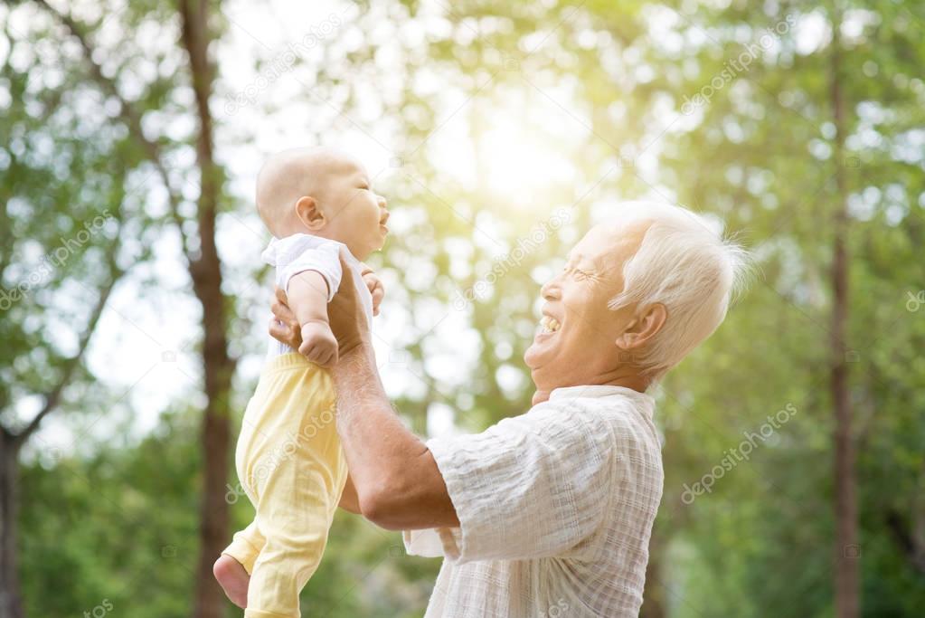 Grandparent carrying grandchild.