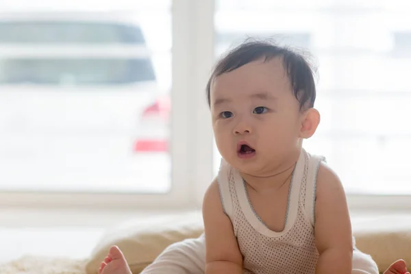 Baby boy sitting on floor. — Stock Photo, Image