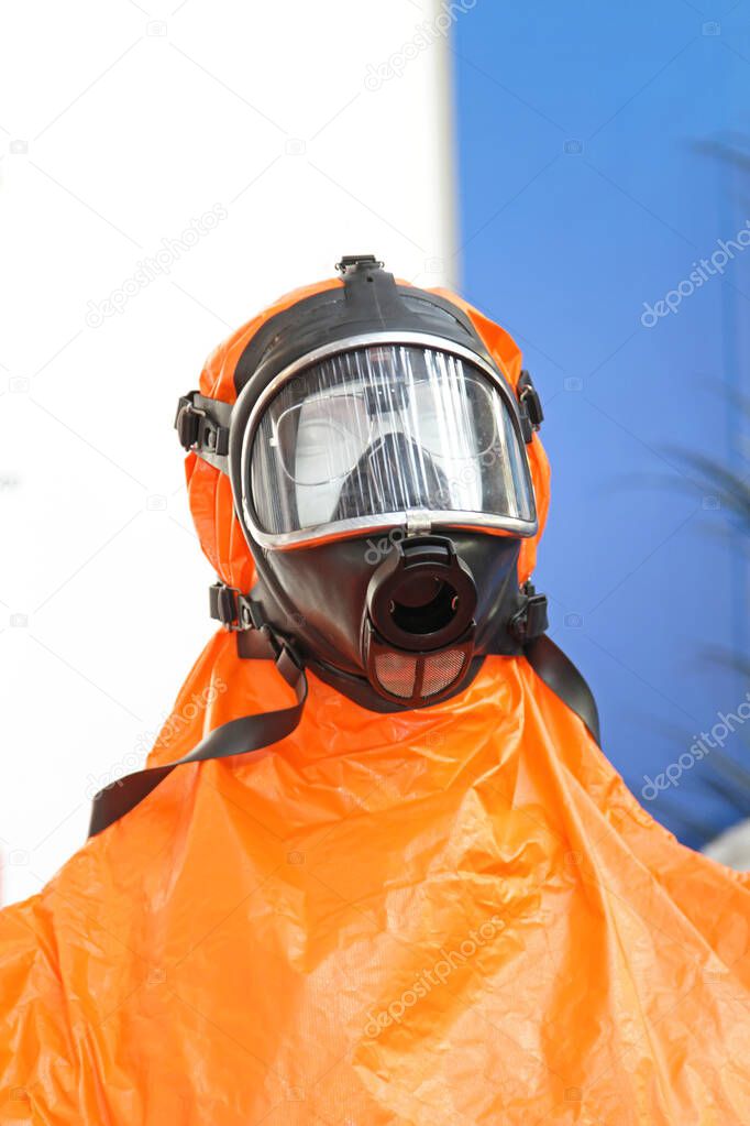 Protective Mask and Orange Hazmat Suit Emergency Equipment