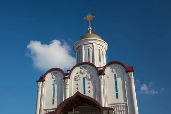 Orthodox church on a background of blue sky with clouds