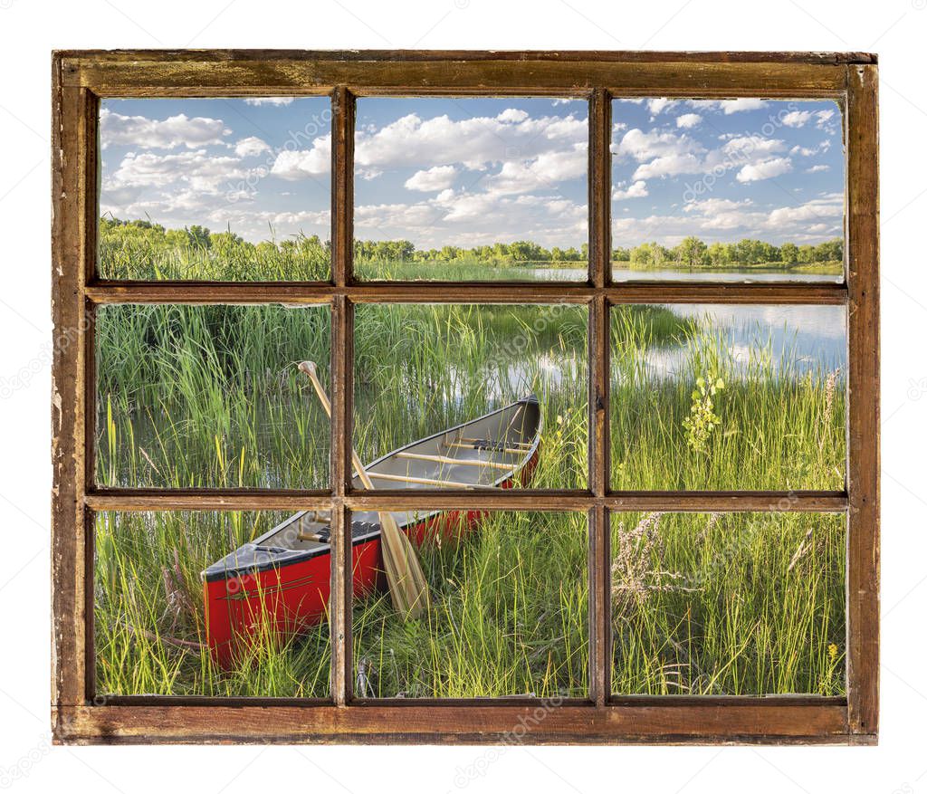 canoe on lake shore - window view
