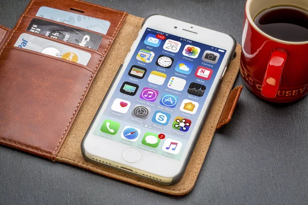 IPhone 7 in leather wallet with coffee — Stock Photo, Image