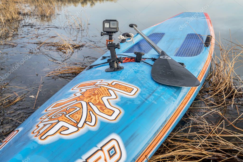 FORT COLLINS, CO - FEBRUARY 18, 2017: Paddling and video making - GoPro Hero 5 camera mounted with a suction cup on a bow of Starboard stand up paddleboard with Quickblades paddle..