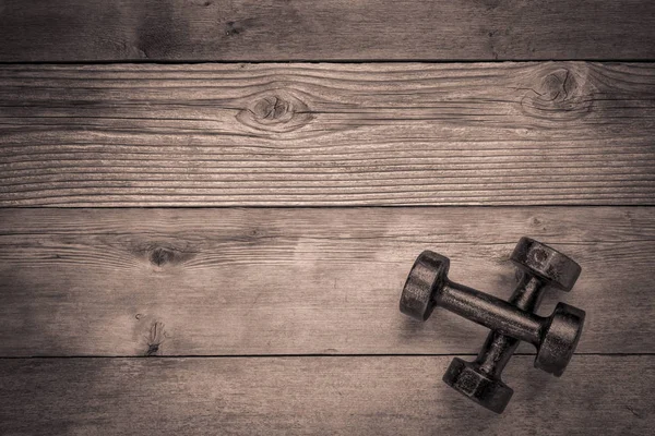 Dumbbells on wood - exercise concept — Stock Photo, Image