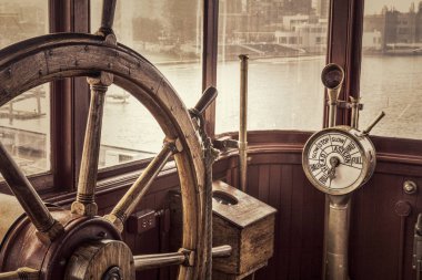 vintage ship steering wheel in sepia toning clipart