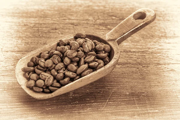 Cucharada de granos de café en tonificación retro — Foto de Stock