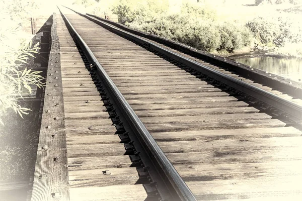 Railroad tracks over river — Stock Photo, Image