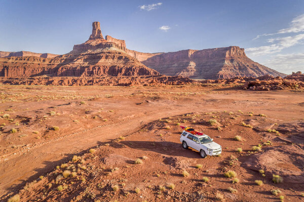 Toyota 4runner SUV with a kayak on roof on a desert trail