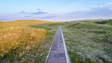 Narrow, one lane road in Nebraska Sandhills clipart