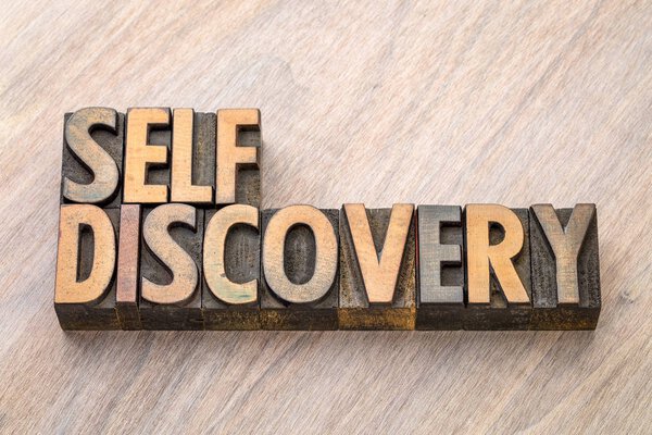 self discovery word abstract in wood type