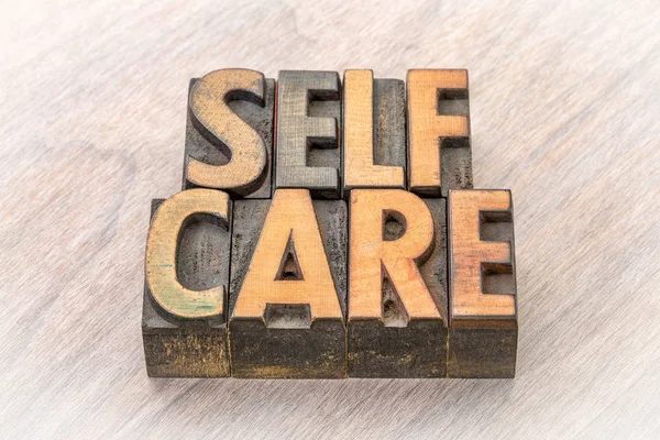 Self-care word abstract in wood type — Stock Photo, Image