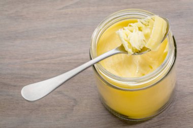 ghee in jar and spoon clipart