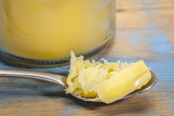 Ghee in jar and spoon — Stock Photo, Image