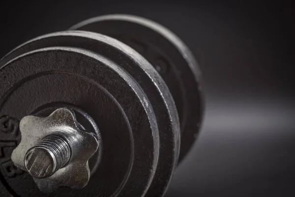 Exercise concept - iron dumbbell abstract — Stock Photo, Image