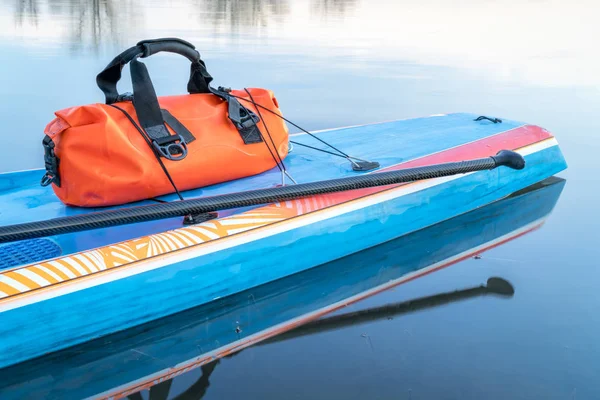 Waterproof duffel on stand up paddleboard — Stock Photo, Image