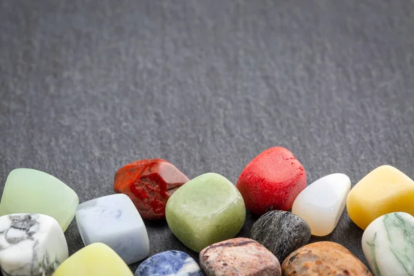 Colorful gemstones on slate stone — Stock Photo, Image