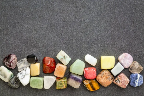 colorful gemstones on slate stone