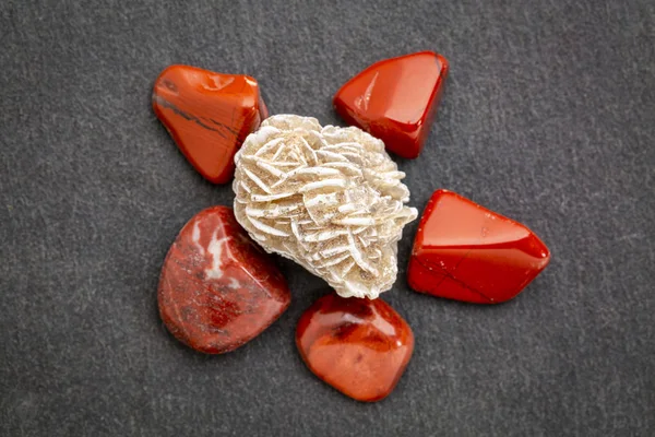 Gypsum rosette with red jasper on slate stone — Stock Photo, Image