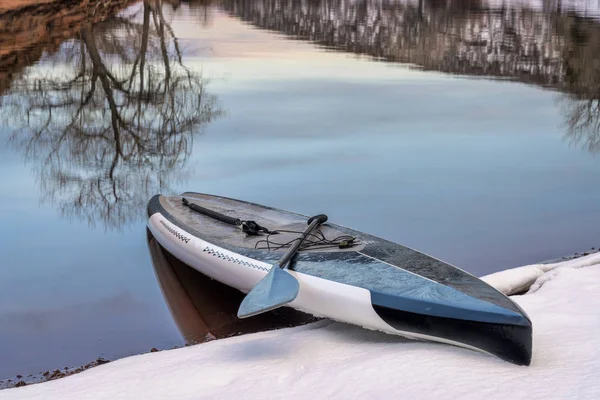 Stand up paddleaboard covered by ice — Stock Photo, Image