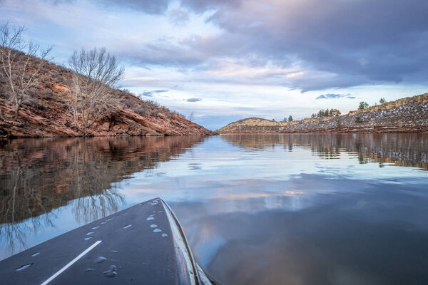 winter stand up paddling on lake in Colorado