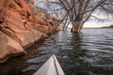 winter paddling on mountain lake in Colorado