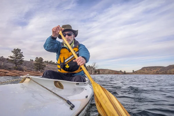 Senior male is paddling expedition canoe — Stock Photo, Image