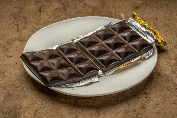 Unwrapped and broken chocolate bar — Stock Photo, Image