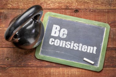 Kettlebell ile tahtanın üzerinde tutarlı bir ilham kaynağı metin - fitness ve kararlılık konsepti