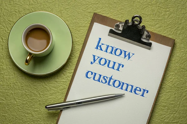 know your customer - handwriting on a clipboard with coffee, business marketing and public relations concept