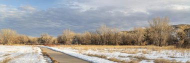 winter scenery on a bike trail - panorama of Poudre River Trail in northern Colorado, biking, recreation and commuting concept clipart