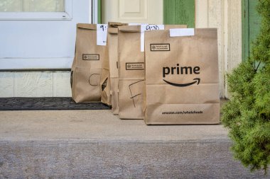 Fort Collins, CO, ABD - 31 Mart 2020: market ve taze ürünlerle dolu kahverengi çantalar Amazon Prime 'dan eve getirildi. Koronavirüs salgını sırasında online alışveriş.