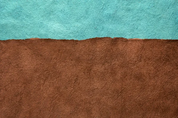 brown field and turquoise blue sky - abstract landscape created with colorful sheets of handmade textured paper