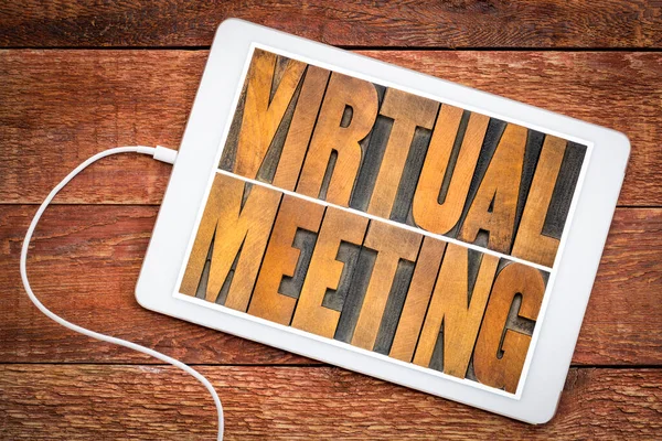 virtual meeting word abstract in vintage letterpress wood type on a digital tablet, networking and telecommunication concept