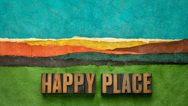 happy place - word abstract in vintage letterpress wood type against abstract paper landscape, joy and happiness concept - a memory, situation, or activity that makes you feel happy