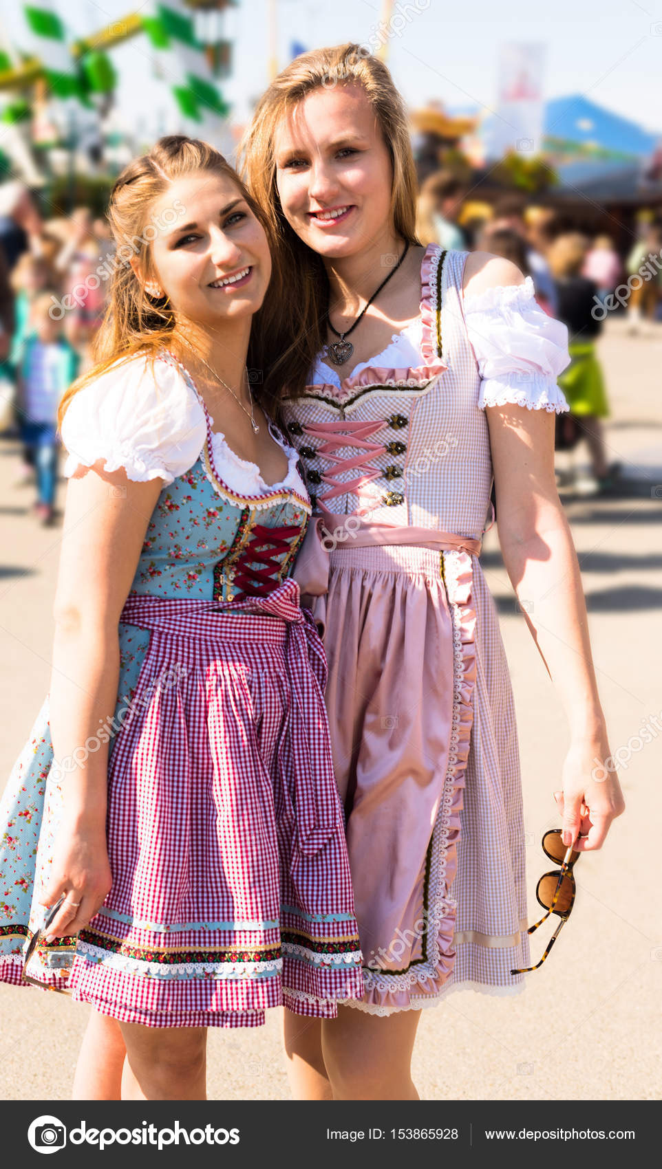 Attractive young women at German funfair Oktoberfest with traditional ...